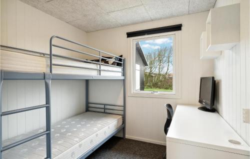 a bedroom with bunk beds and a desk and a window at 4 Bedroom Cozy Home In Vinderup in Vinderup