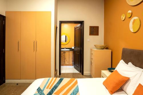 a bedroom with a bed and a bathroom with a sink at Kabira Country Club in Kampala