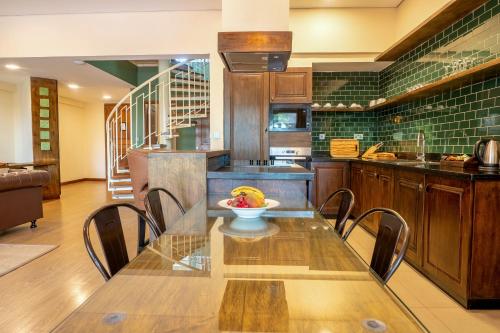 a kitchen with a table with a bowl of fruit on it at Kabira Country Club in Kampala