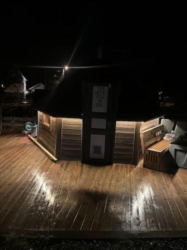 a stage with a wooden deck at night at Arctic apartment Tønsvik in Tromsø