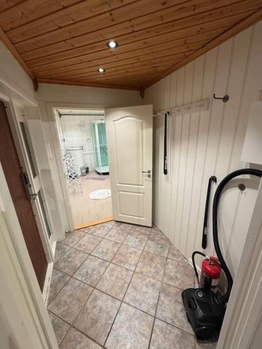 an empty room with a door and a room with a bathroom at Arctic apartment Tønsvik in Tromsø