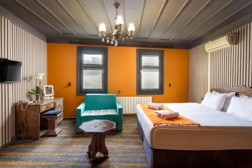 a hotel room with a bed and a chair at Wonder Wood Hotel in Istanbul