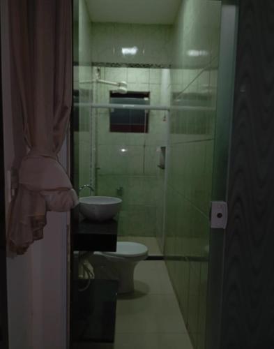 a bathroom with a toilet and a sink at Casa Morais in Guarapari