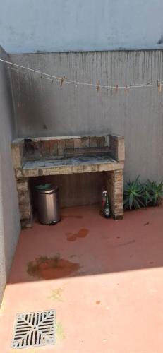 a wooden bench sitting next to a wall at Apart Las Hermanas in Colón