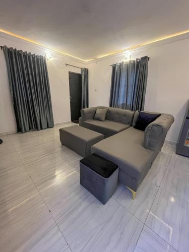 a living room with a couch and a table at Memento Courts in Lagos