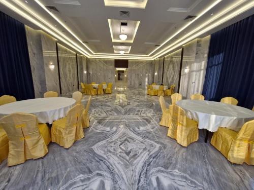 a conference room with two tables and yellow chairs at Ocean View Hotel Kuwait in Kuwait