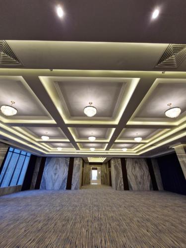 a large room with a ceiling with lights on it at Ocean View Hotel Kuwait in Kuwait