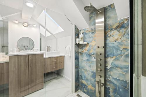 a bathroom with a shower and a sink at 342 Edgewater Inn in Charlevoix
