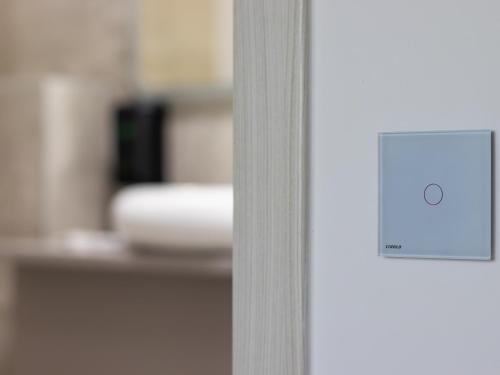 a close up of a door with a lightswitch at Casa Muntenească Alessandro in Piteşti