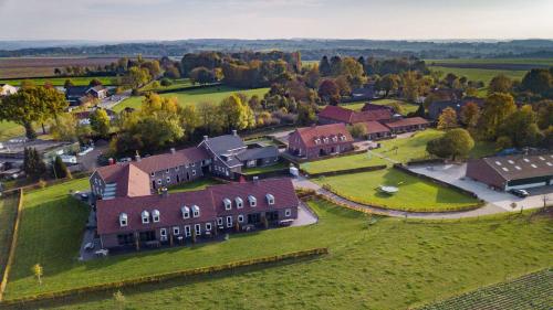 an aerial view of a large house on a green field at Recreatie Landgoed Terlingerhoeve in Noorbeek