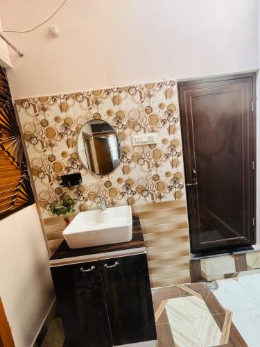 a bathroom with a sink and a mirror at Vindh Homestay in Varanasi