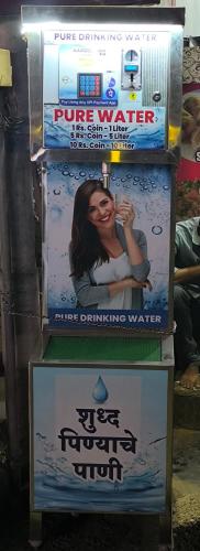 a video game machine with a poster on it at Hotel Swarajya in Kolhapur