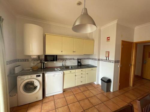 a kitchen with a washing machine and a washer at Superbe appartement vue mer et falaises in Lagos