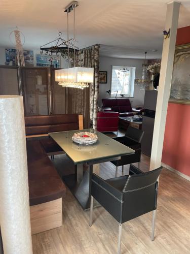 a dining room and living room with a table and chairs at Luckylake in Muhr amSee