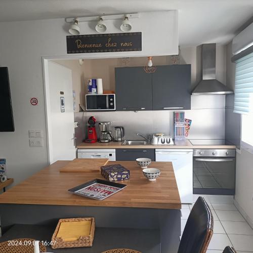 a kitchen with a wooden table in a kitchen at L'escale N°13 :Appartement standing dans résidence in Brest