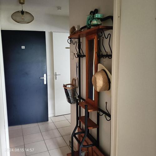 a hallway with a blue door and a shelf at L'escale N°13 :Appartement standing dans résidence in Brest