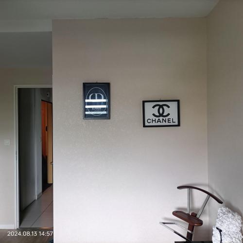 two signs on a wall with a chair on it at L'escale N°13 :Appartement standing dans résidence in Brest