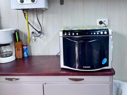 a microwave sitting on top of a counter at FRОDО - Cozy as a home for 4-6 persons in Tashkent