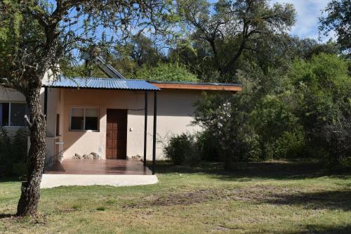 a small house with a porch in a yard at Campo de los Zorros in Nono