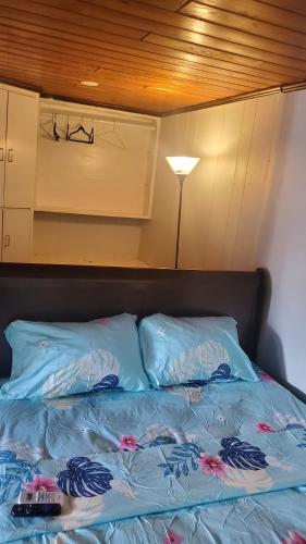 a bed with two pillows on top of it at Private Studios Orlando in Orlando