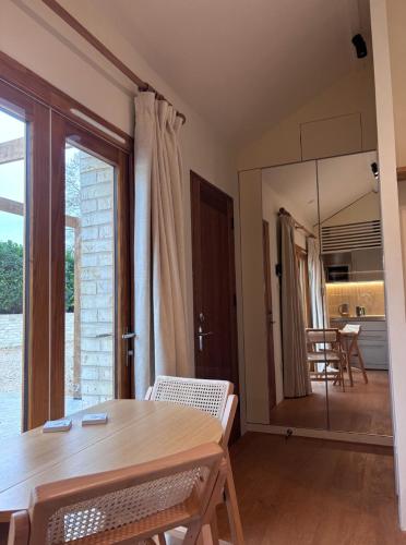 a dining room with a table and a mirror at The Stables at Minstrel Court in Cambridge