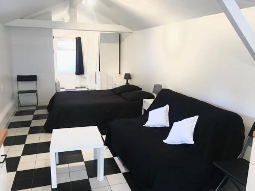 un salon avec deux lits et un canapé dans l'établissement À cabin on town, à Choisy-le-Roi