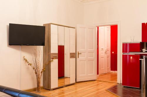 a living room with a mirror and a red refrigerator at Hotel Spreewitz am Kurfürstendamm in Berlin