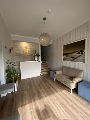 a living room with a couch and a table at Hotel Dom Lourenco in Areia Branca