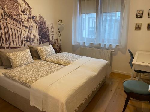 a bedroom with a bed and a desk and a window at Cozy City Appartement Warszawa in Warsaw