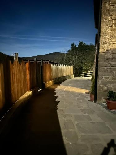 a shadow of a fence next to a sidewalk at B&B A…Monte in Santa Maria