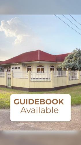 a house with a sign that reads guldeboot available at Paramaribo Villa Near Vibrant District incl Kitchen Household Service in Paramaribo