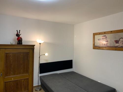 a bedroom with a bed and a painting on the wall at Apartmány na Vršku in Plzeň