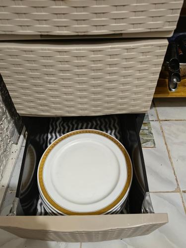 a white toilet in a drawer with a basket at Cozy Townhouse own parking Wi-Fi in Baguio