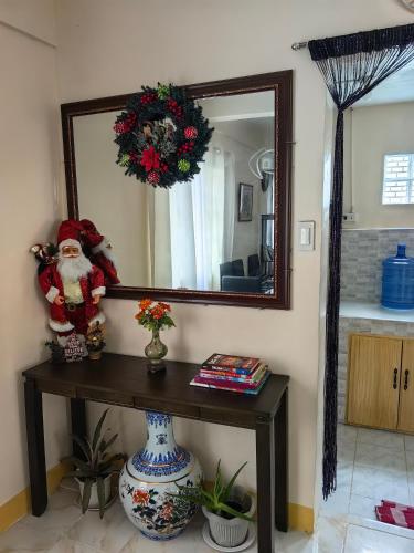 a mirror with a santa clause on a table in a room at Cozy Townhouse own parking Wi-Fi in Baguio