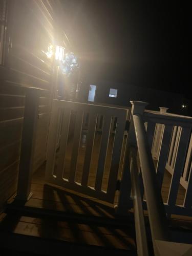 a person standing next to a wooden fence in the dark at 25 cherry tree in Gristhorpe