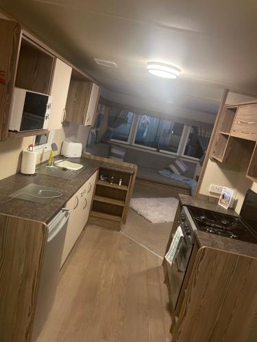 a small kitchen with a view of a room at 25 cherry tree in Gristhorpe