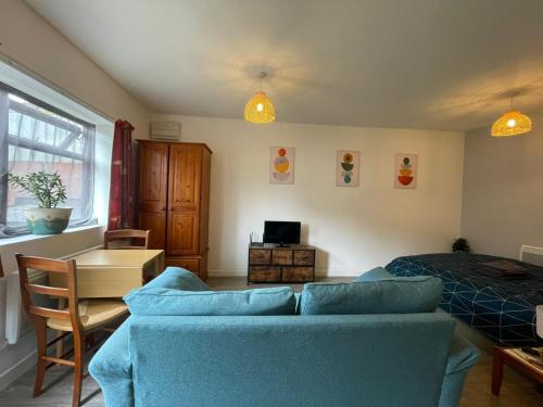 a living room with a couch and a bed at Jim's place in Bristol