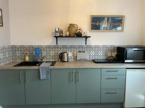a kitchen with a counter top with a microwave at Jim's place in Bristol