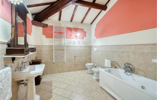 a bathroom with a tub and a toilet and a sink at Villa Pieve, Lucignano in Lucignano
