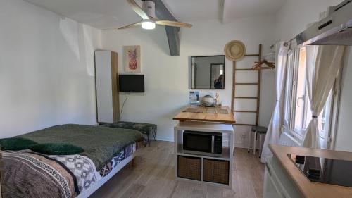 - une petite chambre avec un lit et un comptoir dans l'établissement STUDIO avec PARKING TOUT A PIED et CALME, à Bandol