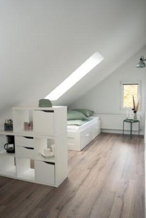 a white bedroom with a bed and a window at Zentrale Ferienwohnung in Bielefeld