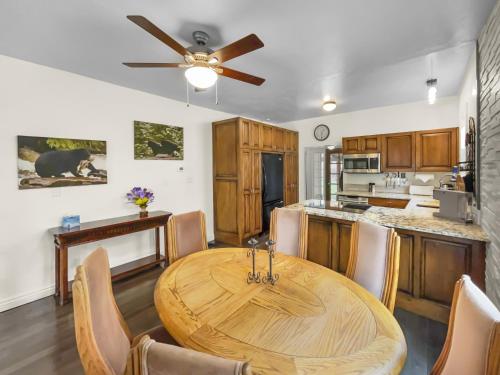 a dining room with a wooden table and a kitchen at Reminiscent Downtown Cottage cottage in Grand Junction