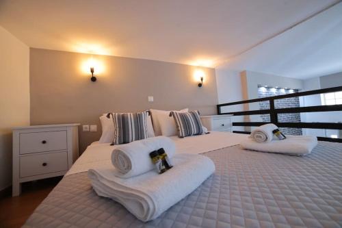 a bedroom with two beds with towels on them at loft apartment in Athens