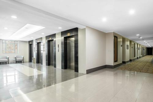 a hallway of a building with doors and chairs at Elaf Bakkah Hotel in Makkah