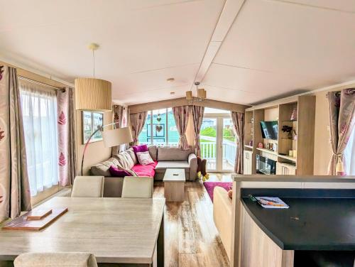 a living room with a couch and a table at Jenny and Jamie's holiday home on the edge in Morecambe