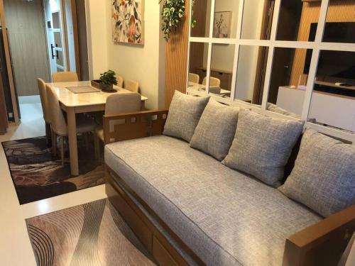 a living room with a couch and a table at 2BR Unit in SMDC Shore 3 with pool access in Manila