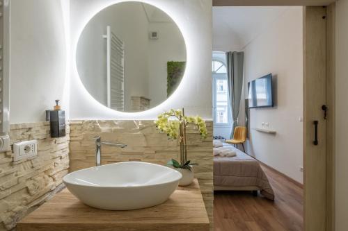 a bathroom with a white tub and a mirror at Via Roma 106 Apartment in Sassari