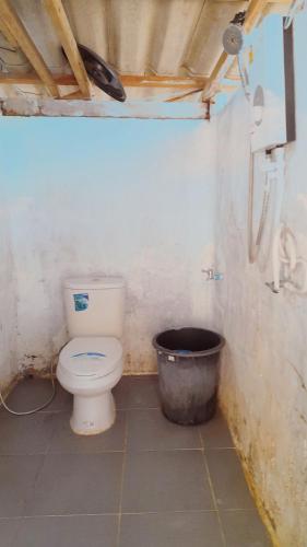 a bathroom with a toilet and a bucket at neena s Dormitory in Ko Phangan