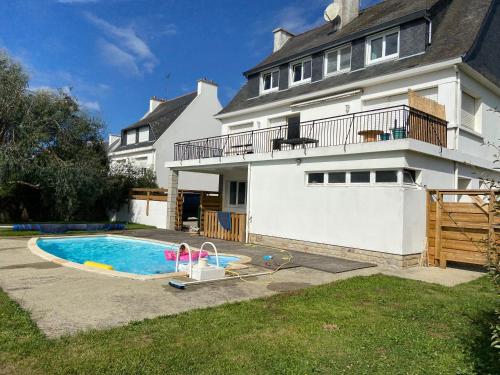 une maison avec une piscine devant une maison dans l'établissement Gite d aventure, à Névez