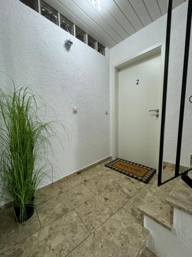 a garage with a white door and a plant at Via Roma 257 Apartament in Cochem